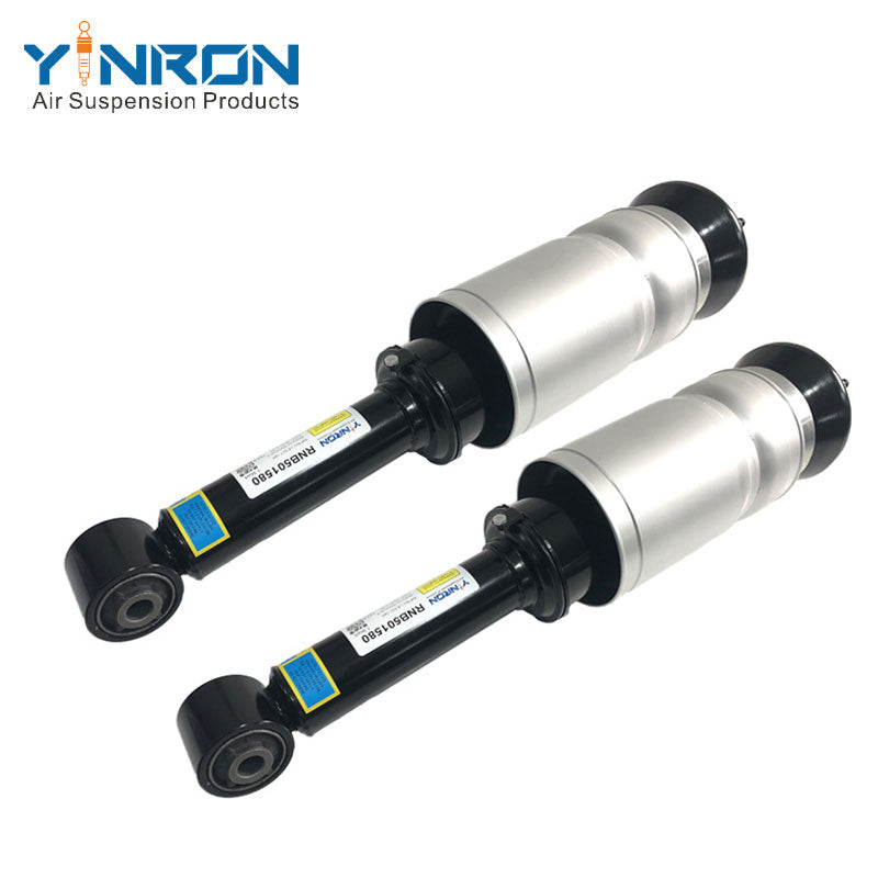 45-degree view of paired front air suspension struts for Land Rover Discovery 3 / Range Rover Sport L320 (non-VDS), part number RNB501580 set