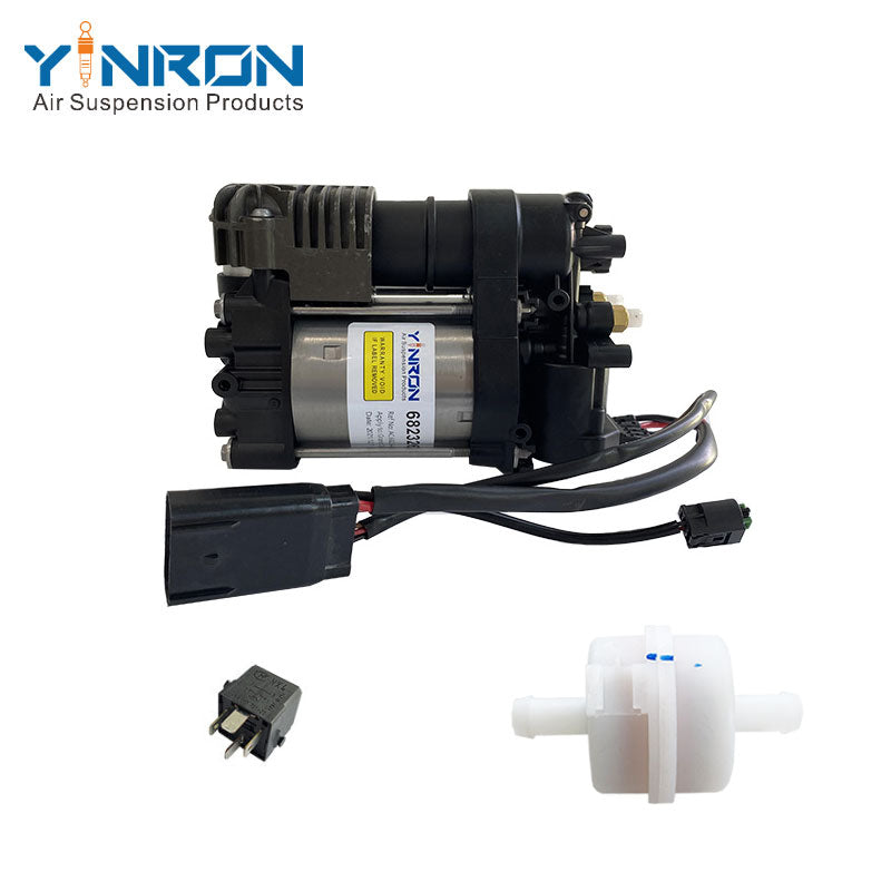 Eye-level full view of Jeep Grand Cherokee air suspension compressor pump OE 68232648AA with relay and air filter