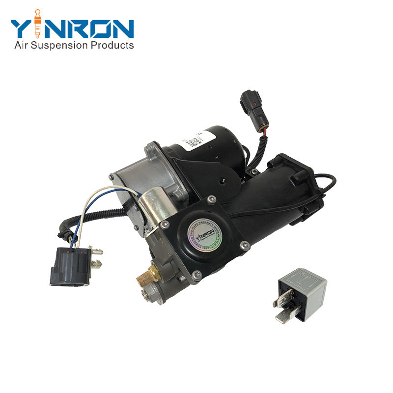 Close-up detail view of Land Rover Range Rover Vogue L322 air suspension compressor pump LR025111 and Hitachi relay